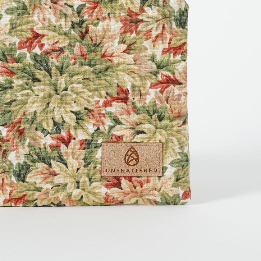 A tan label on the right corner of the leaf pattern zip pouch named after Lynette