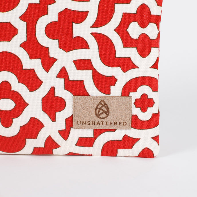 A tan label on a red and white design zip pouch 