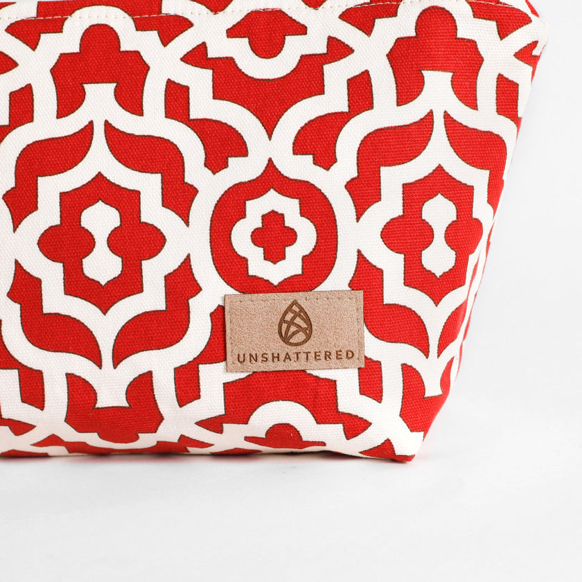 A tan label on a red and white design makeup kit 