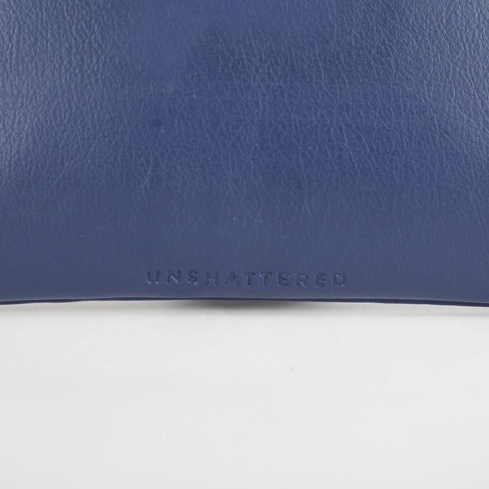 A detail shot of the Unshattered embossed on the back of the anniversary bag