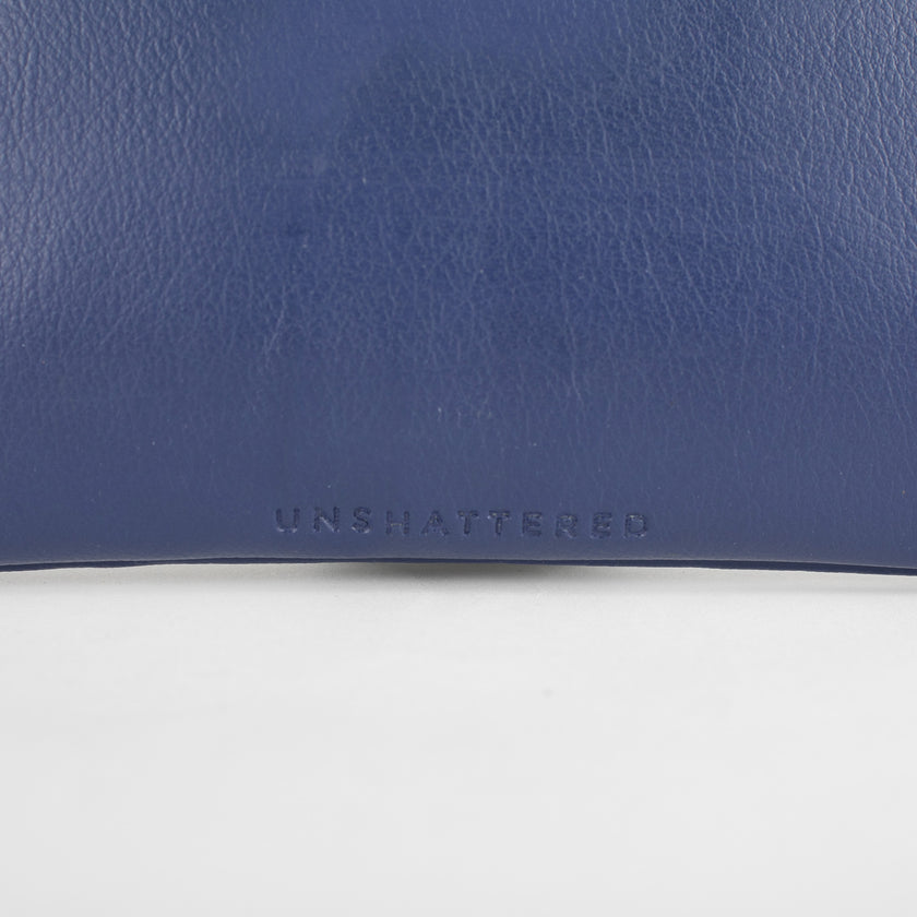 A detail shot of the Unshattered embossed on the back of the anniversary bag
