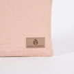 detail shot of the tan label on this pink and yellow zip pouch named after Susan 