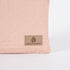 detail shot of the tan label on this pink and yellow zip pouch named after Susan 