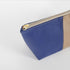 A gold tone zipper on this blue southwest makeup bag