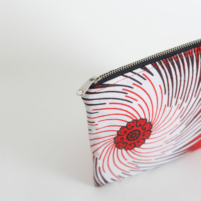 Zipper pouch with red and black pattern on a white background named after Aiyannah 
