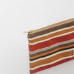 Striped pouch with a gold zipper on a white background