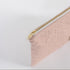 a gold toned zipper on a pink and yellow zip pouch 