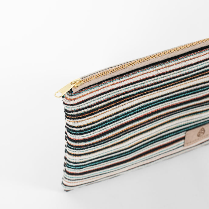 A detail shot of the gold tone zipper on this multicolor zip pouch 