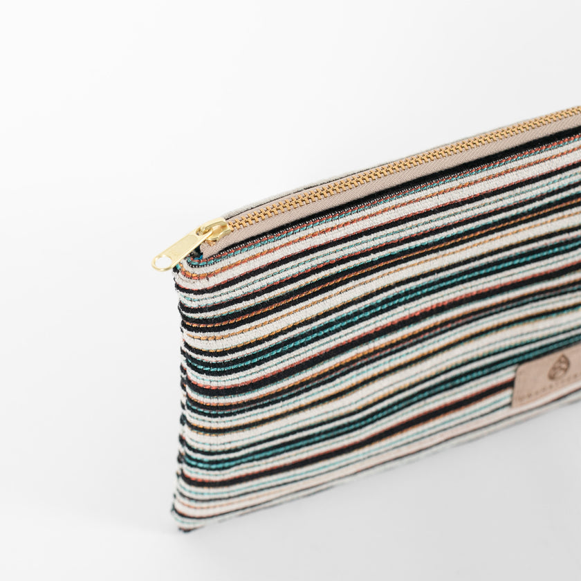 A detail shot of the gold tone zipper on this multicolor zip pouch 