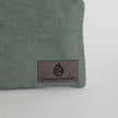 Green fabric with 'Unshattered' logo on a white background