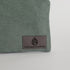 Green fabric with 'Unshattered' logo on a white background