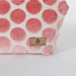Makeup kit with pink polka dots and 'Unshattered' brand label on a white background