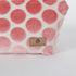 Makeup kit with pink polka dots and 'Unshattered' brand label on a white background