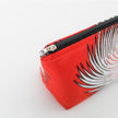 Red makeup bag with silver zipper on a white background named after Marie 