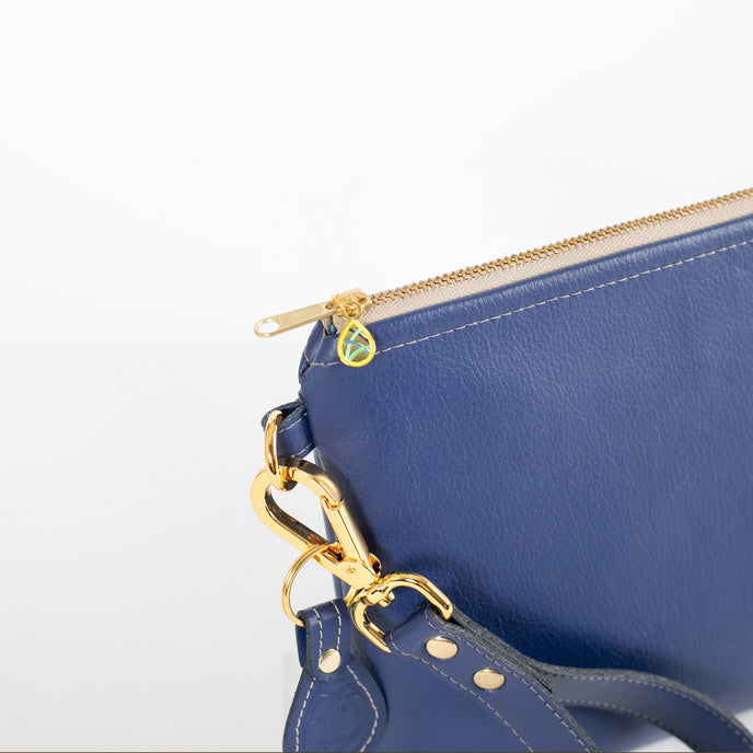A detail zipper shot of the tan zipper and Unshattered emblem.