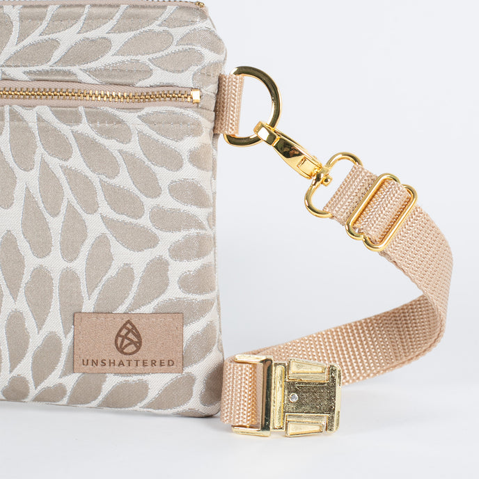 a detail shot of the gold belt bag clip 
