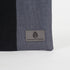 A gray Unshattered label on a West Point dress gray zip pouch 