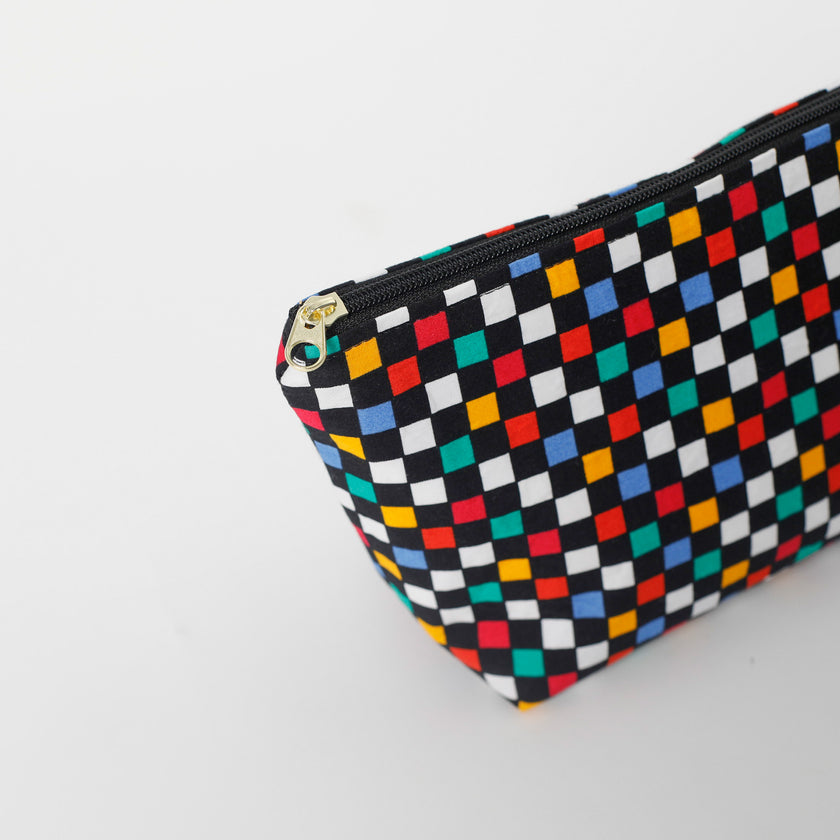 Colorful checkered makeup bag with a gold zipper on a white background named after Luisa 