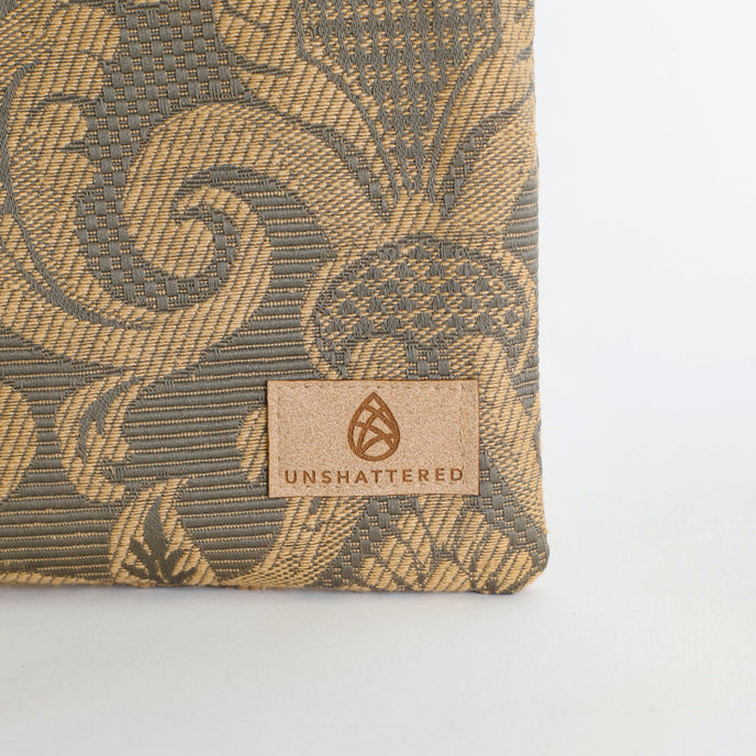 Textured product with 'Unshattered' brand label on a light gray background named after Salina