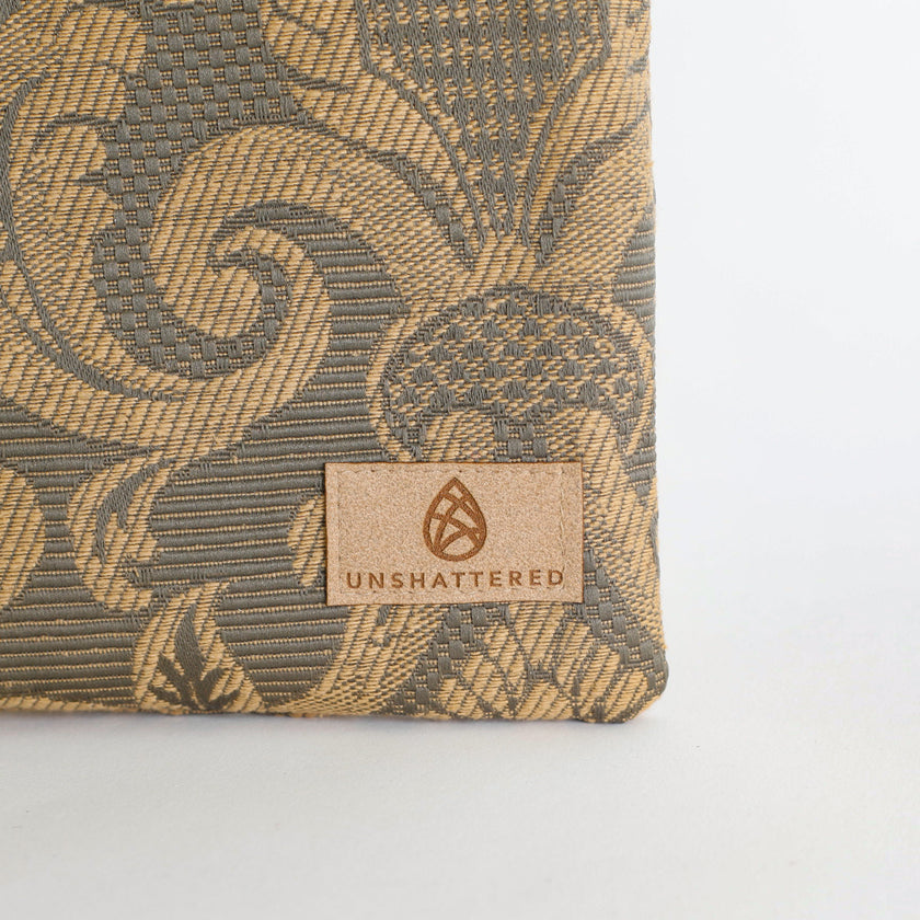 Textured product with 'Unshattered' brand label on a light gray background named after Salina