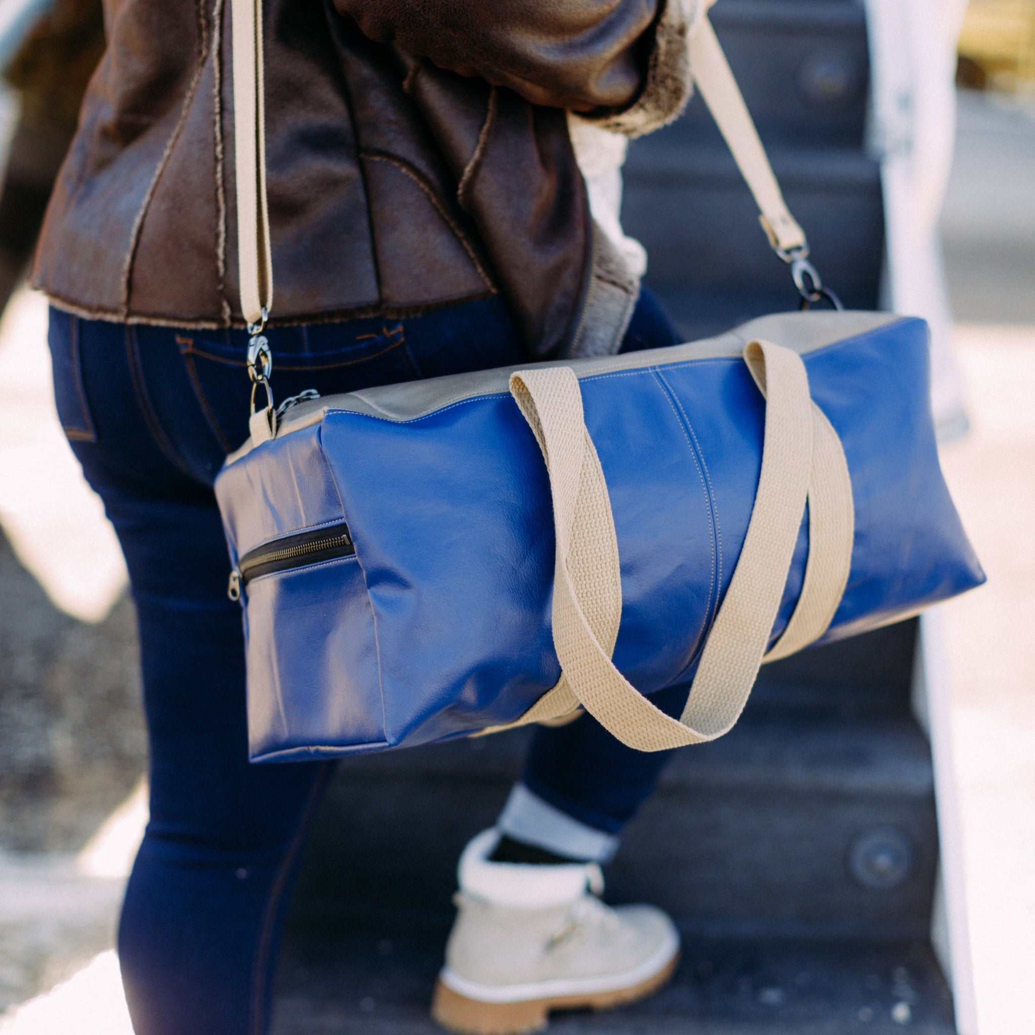 woman carrying Southwest Airline Leather Duffle Bag